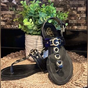 Black thong sandals with gold accents